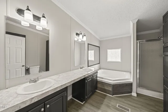 a bathroom with a granite countertop tub sink and mirror