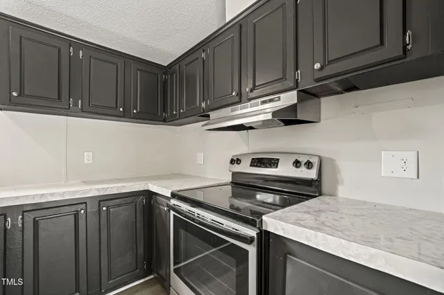 a kitchen with granite countertop cabinets and steel stainless steel appliances