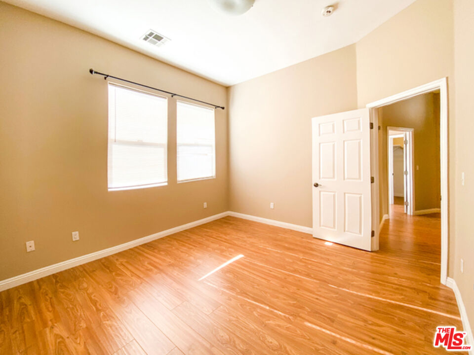 904 East Windsor Road, Unit 103 Glendale, CA 91205 - Photo 13 of 18 a view of an empty room with wooden floor and a window