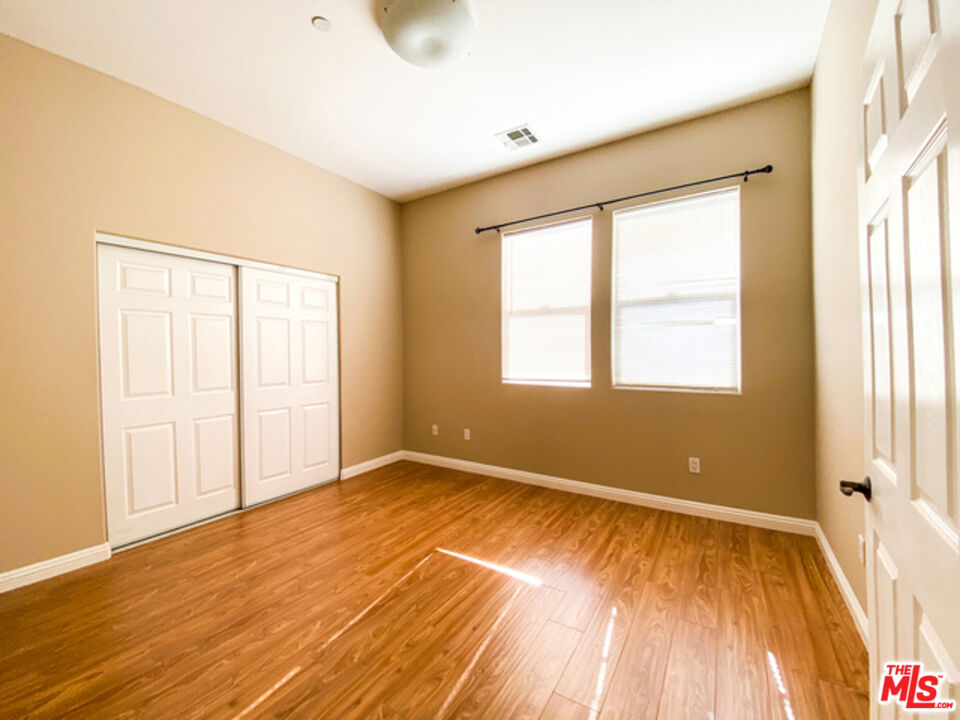 904 East Windsor Road, Unit 103 Glendale, CA 91205 - Photo 14 of 18 a view of an empty room with wooden floor and a window