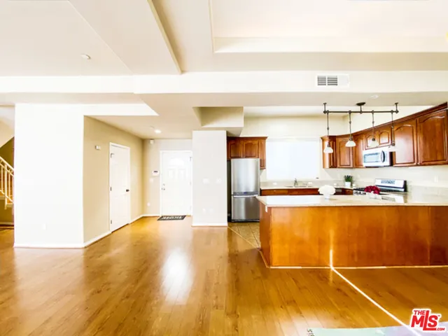 a view of kitchen with cabinets and wooden floor