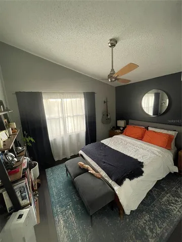 a bedroom with bed and window