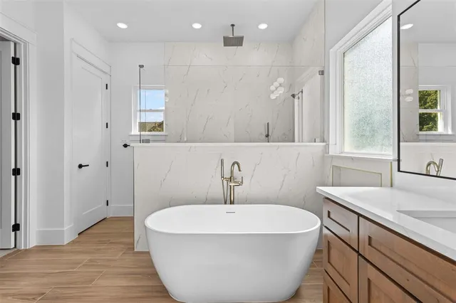 a spacious bathroom with a sink and a mirror