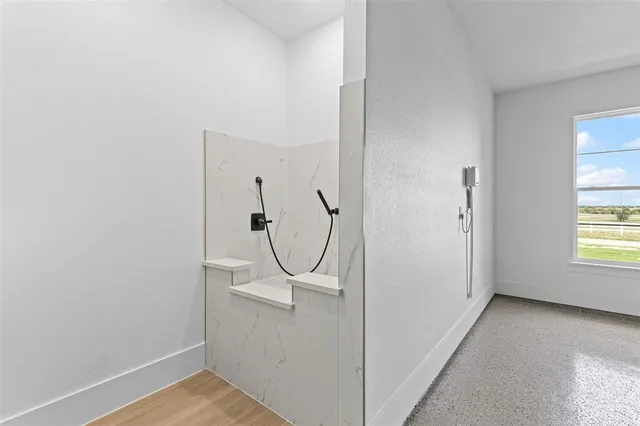 a view of a room with rack on the wall and a window