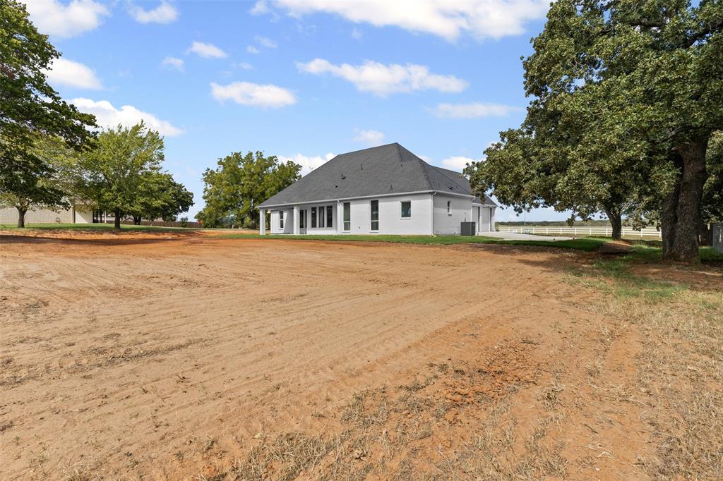 1132 Dobbs Trail Springtown, TX 76082 - Photo 29 of 32 a view of a house with a yard