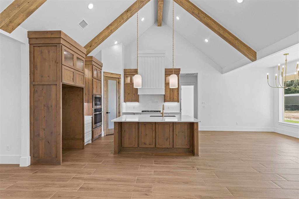 1132 Dobbs Trail Springtown, TX 76082 - Photo 10 of 32 a view of cabinets a sink and a refrigerator in a room