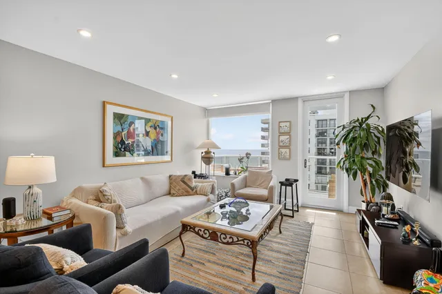 a room with furniture and large windows