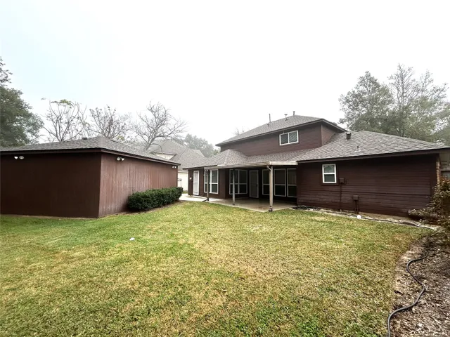 a house that has a big yard with wooden fence