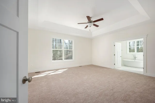 a view of a livingroom with a ceiling fan and window