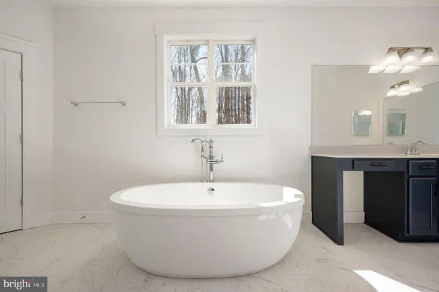 a white bath tub sitting next to a bathroom