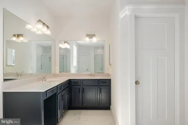 a bathroom with double vanity sinks and a mirror