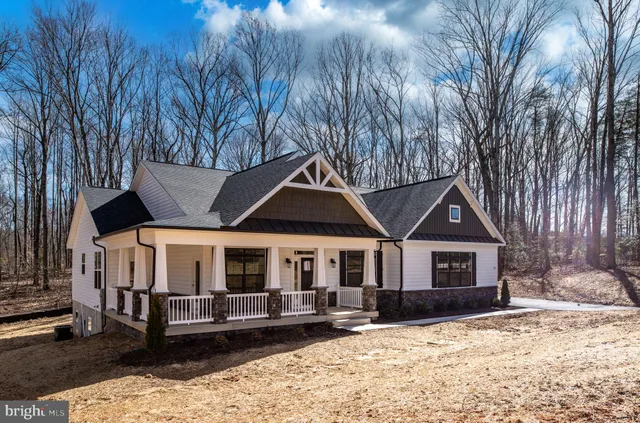 a front view of a house with yard covered in snow