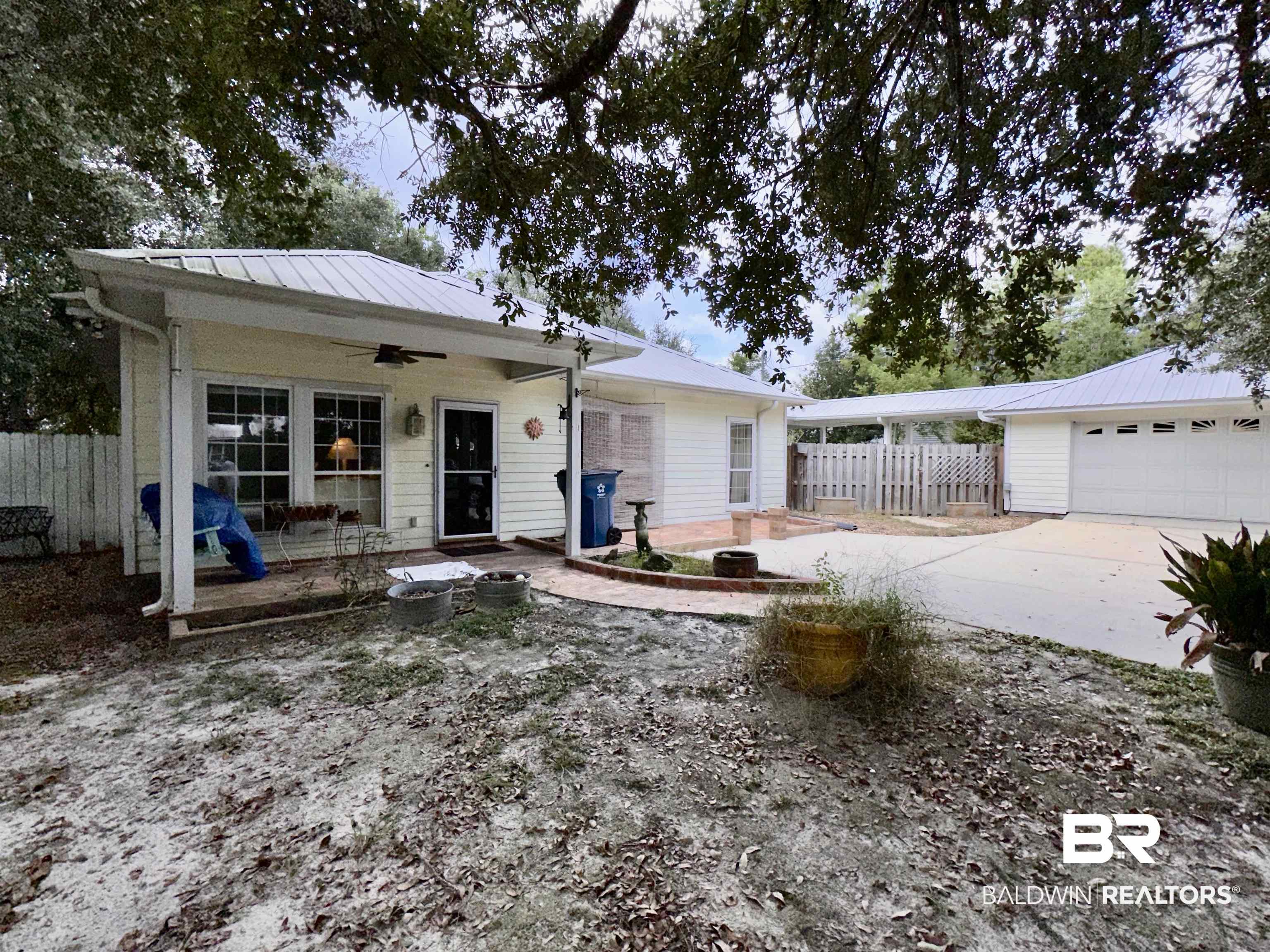 9101 Coronada Road Elberta, AL 36530 - Photo 27 of 27 View of front of home with ceiling fan, a garage, and a metal roof
