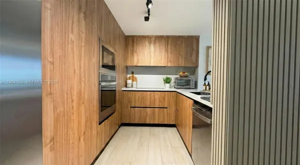 a kitchen with sink and refrigerator