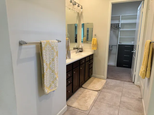a bathroom with a double vanity sink and mirror