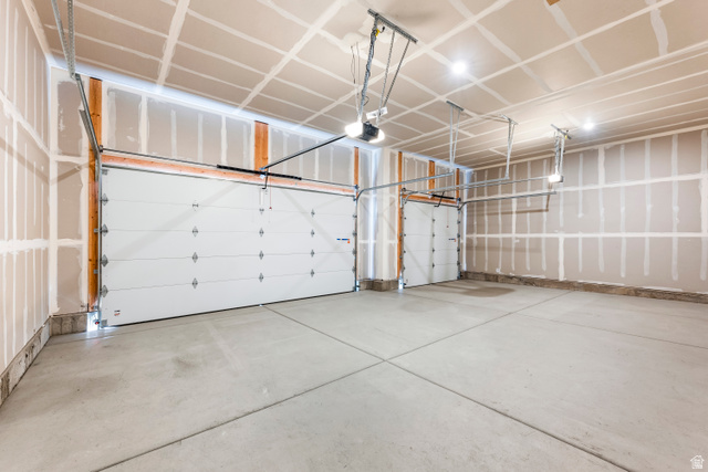 58 South Crimson Way, Unit 306 Mapleton, UT 84664 - Photo 24 of 24 Two white sectional garage doors with exposed framing