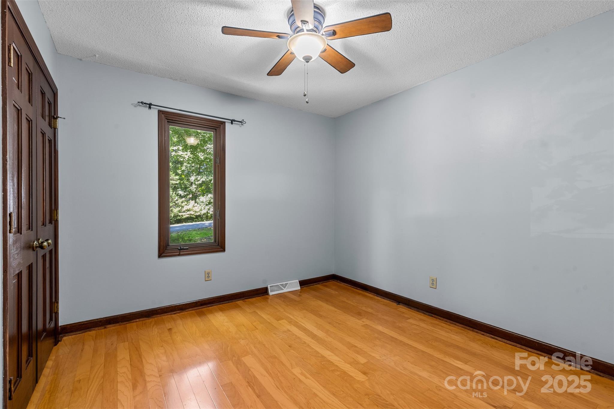 14024 Springwater Drive Matthews, NC 28105 - Photo 12 of 36 an empty room with chandelier fan and windows