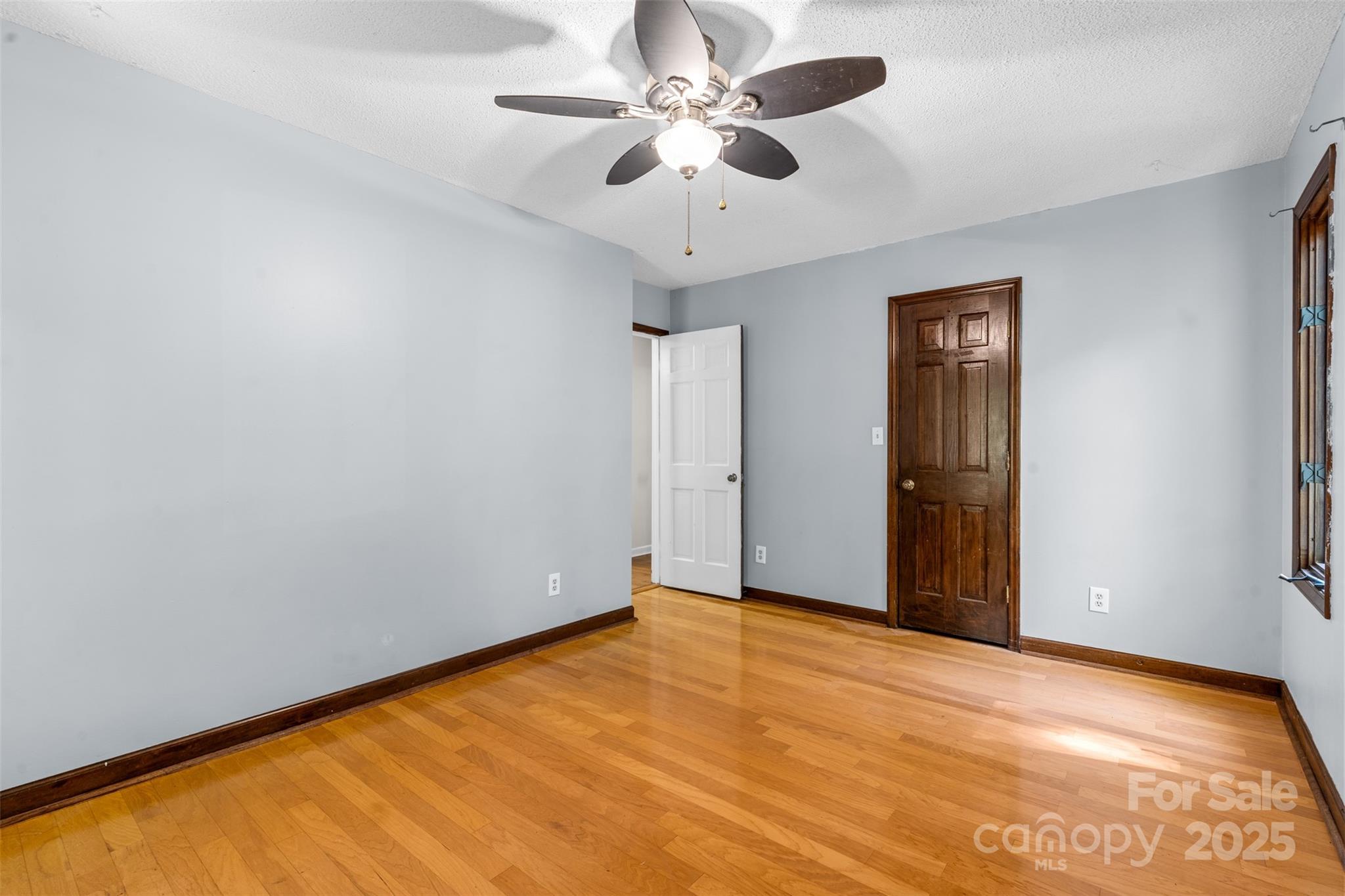 14024 Springwater Drive Matthews, NC 28105 - Photo 16 of 36 a view of an empty room with a chandelier fan