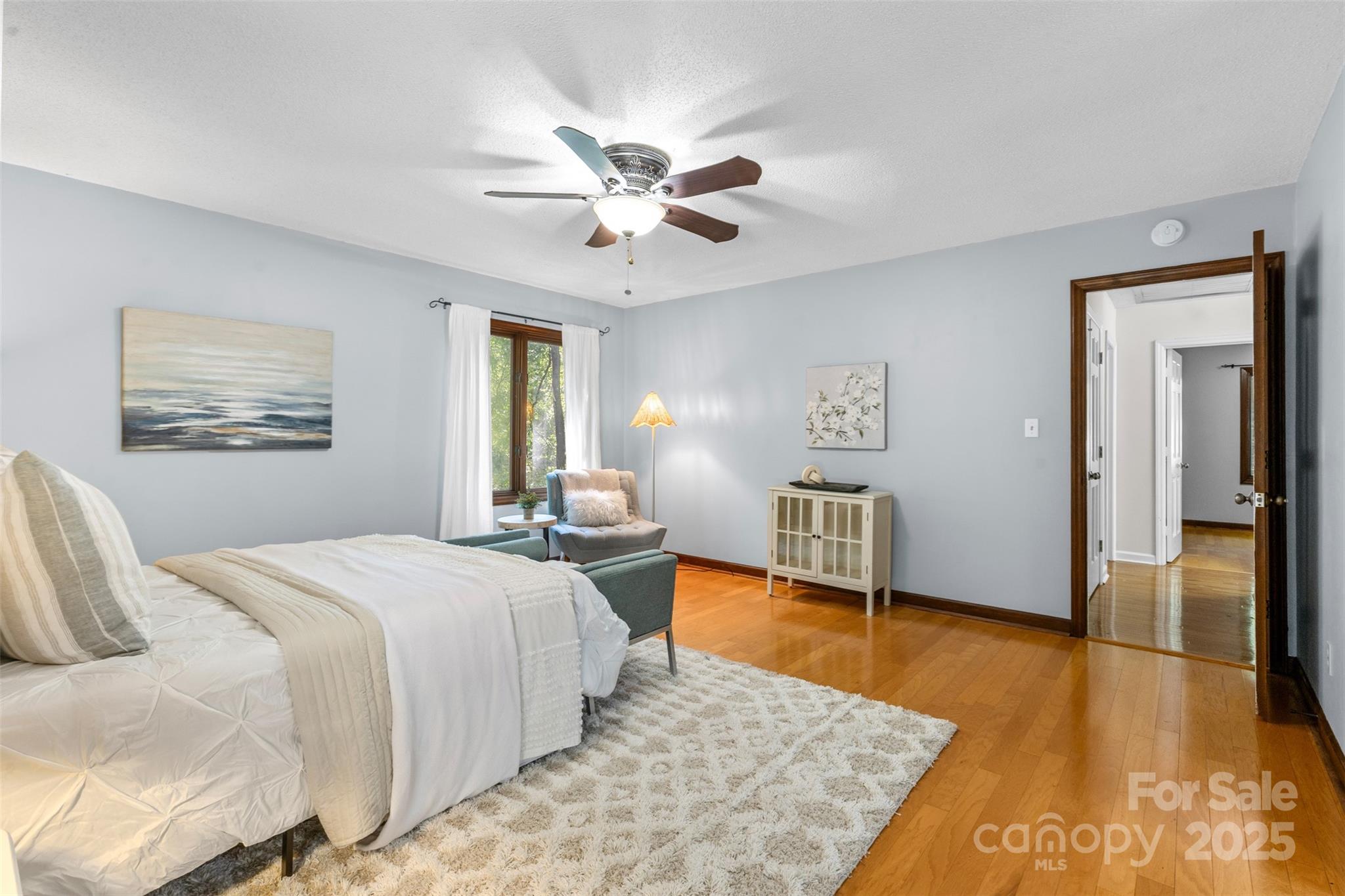14024 Springwater Drive Matthews, NC 28105 - Photo 20 of 36 a bedroom with a bed and a chandelier