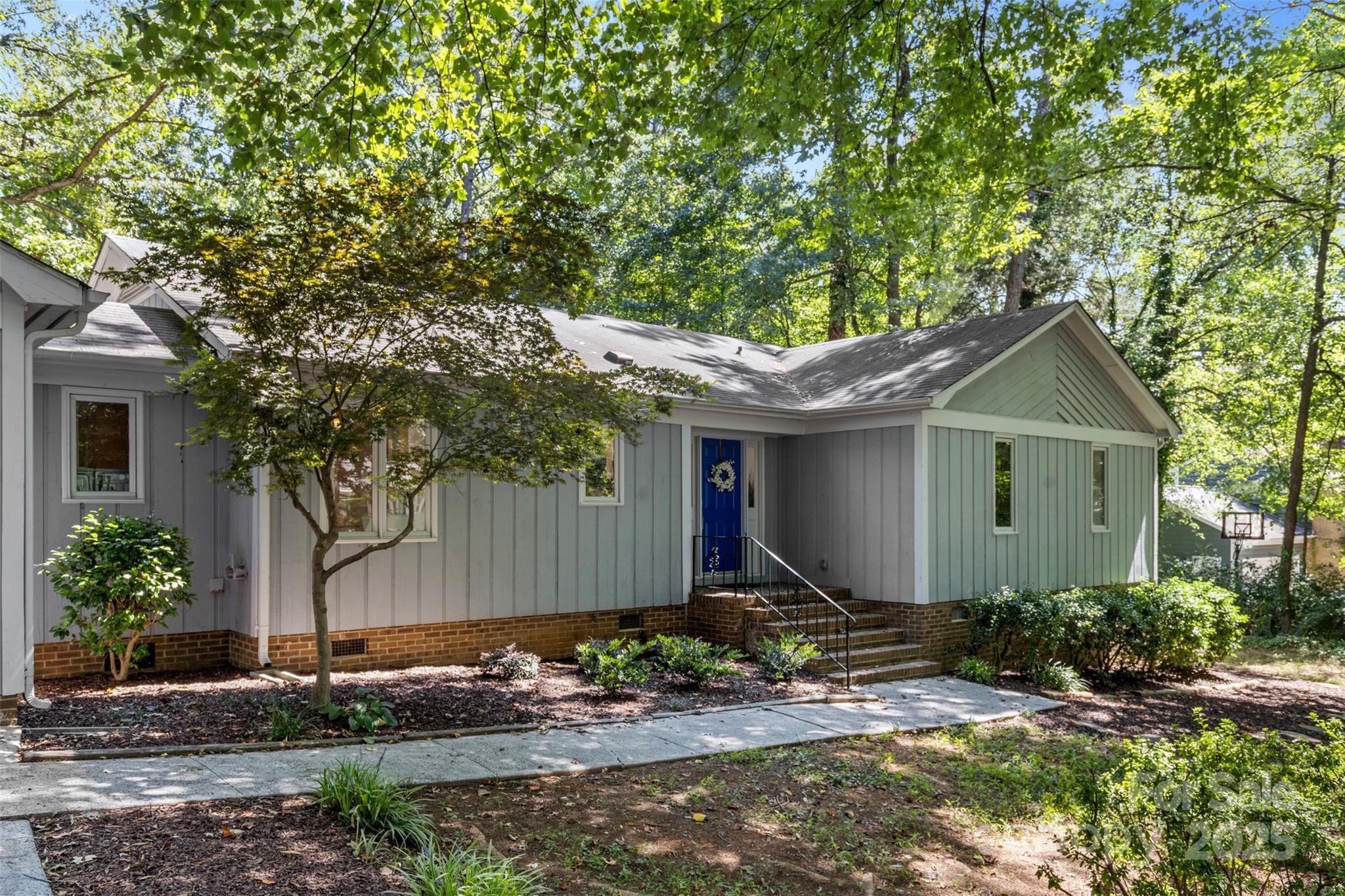 14024 Springwater Drive Matthews, NC 28105 - Photo 2 of 36 a front view of a house with garden