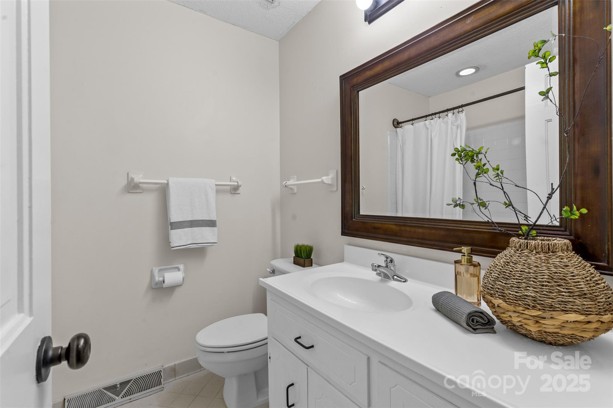 14024 Springwater Drive Matthews, NC 28105 - Photo 25 of 36 a bathroom with a granite countertop sink and a mirror