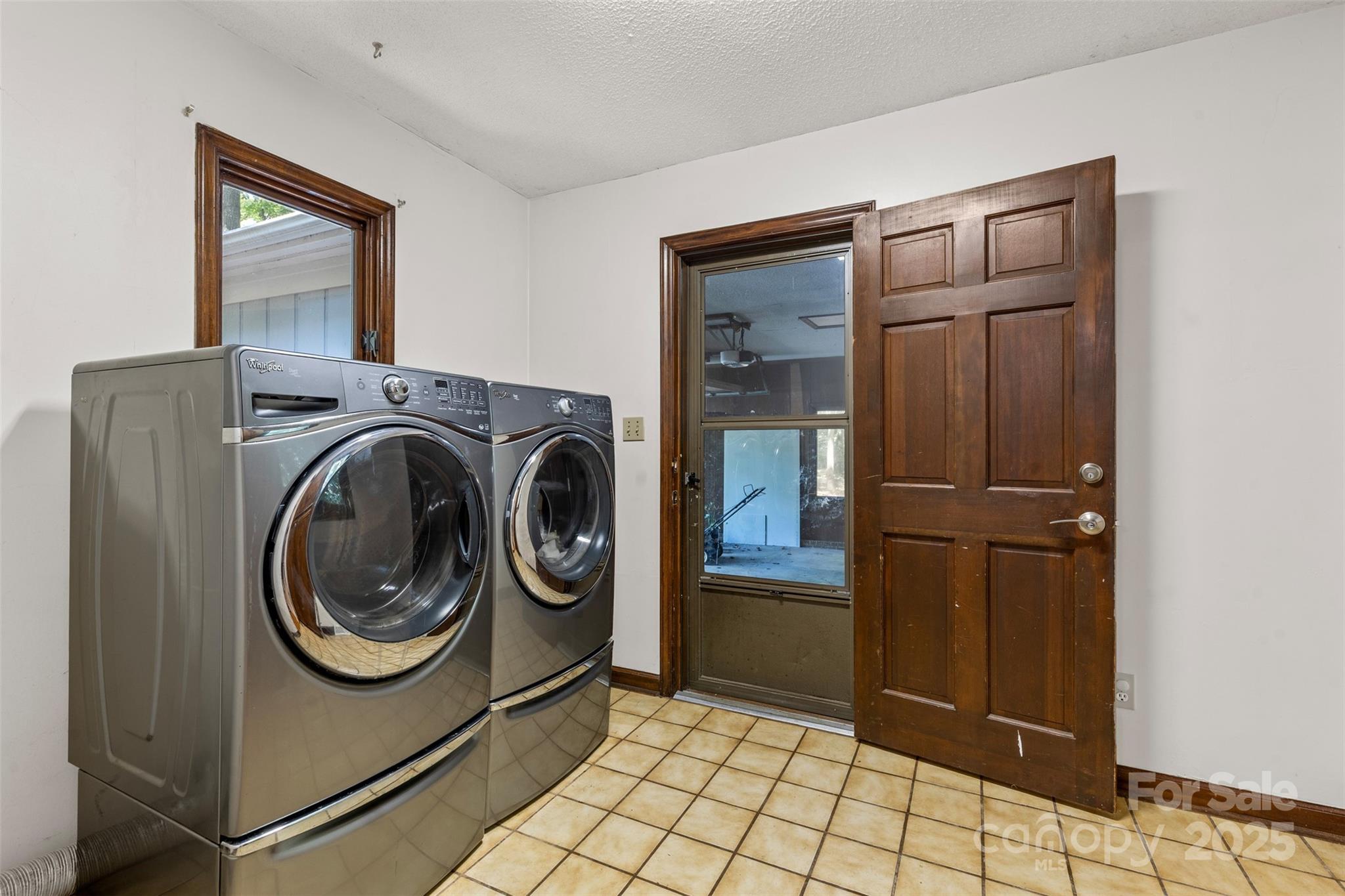 14024 Springwater Drive Matthews, NC 28105 - Photo 26 of 36 a utility room with dryer and washer