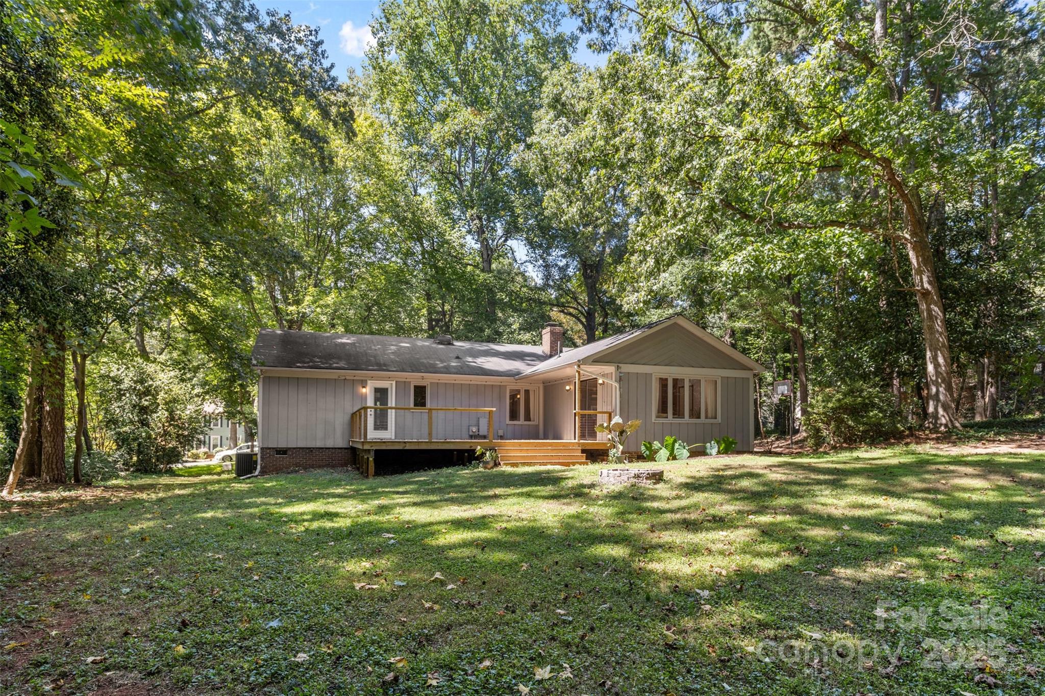 14024 Springwater Drive Matthews, NC 28105 - Photo 32 of 36 a front view of a house with a garden and trees