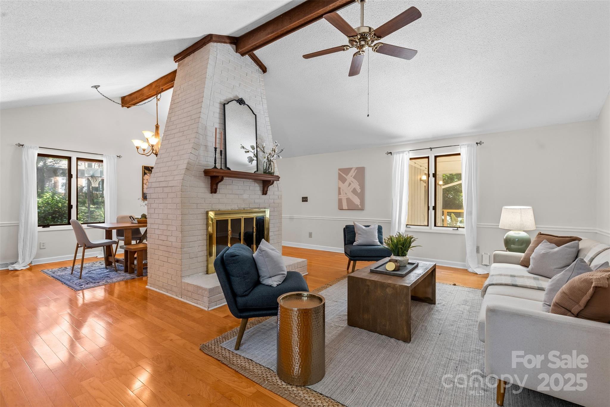 14024 Springwater Drive Matthews, NC 28105 - Photo 4 of 36 a living room with furniture a fireplace and a chandelier