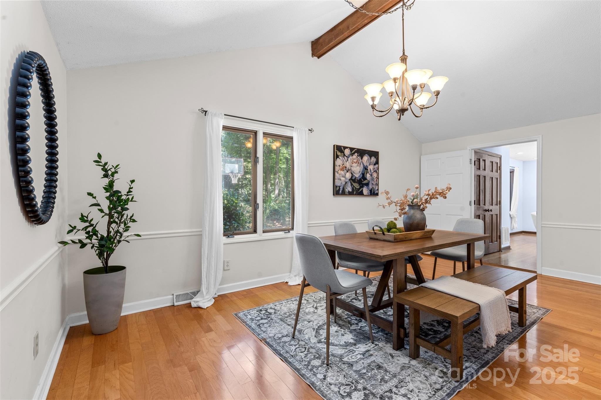 14024 Springwater Drive Matthews, NC 28105 - Photo 7 of 36 a view of a dining room with furniture and chandelier