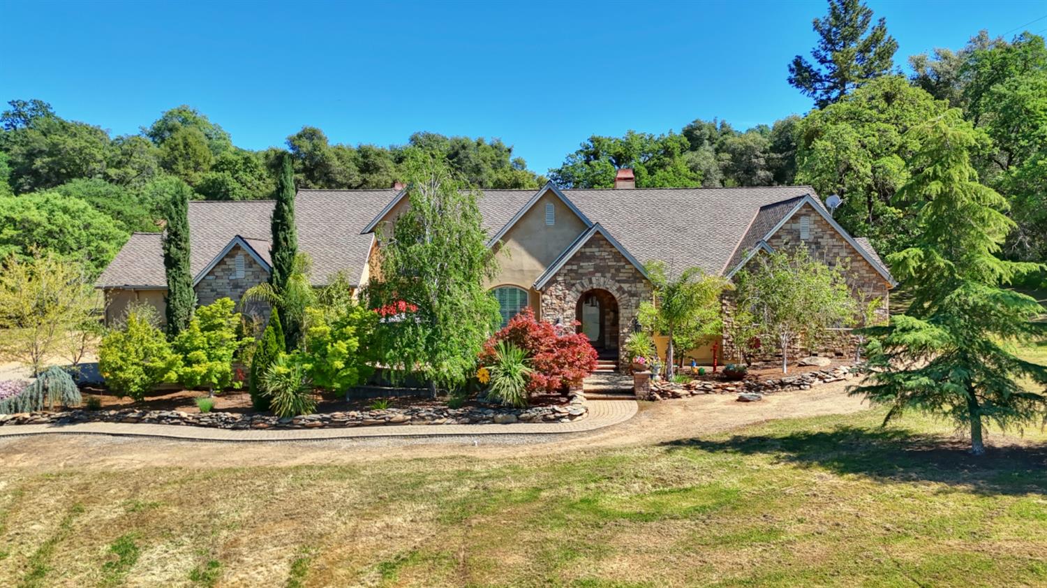 an aerial view of a house with swimming pool garden and patio