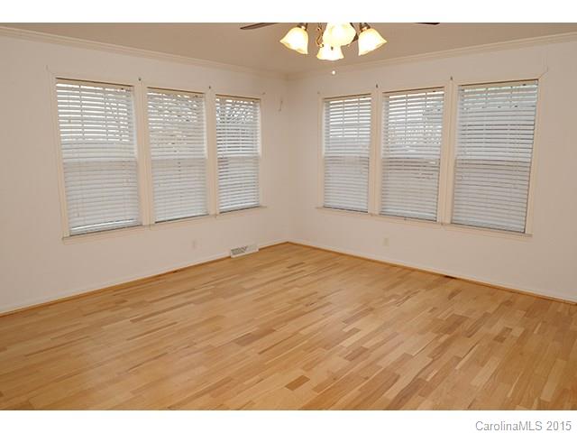 205 Phifer Road Cleveland, NC 27013 - Photo 14 of 17 an empty room with wooden floor and windows