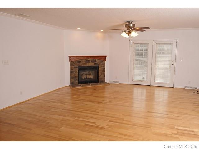 205 Phifer Road Cleveland, NC 27013 - Photo 9 of 17 a view of an empty room with wooden floor and a fireplace