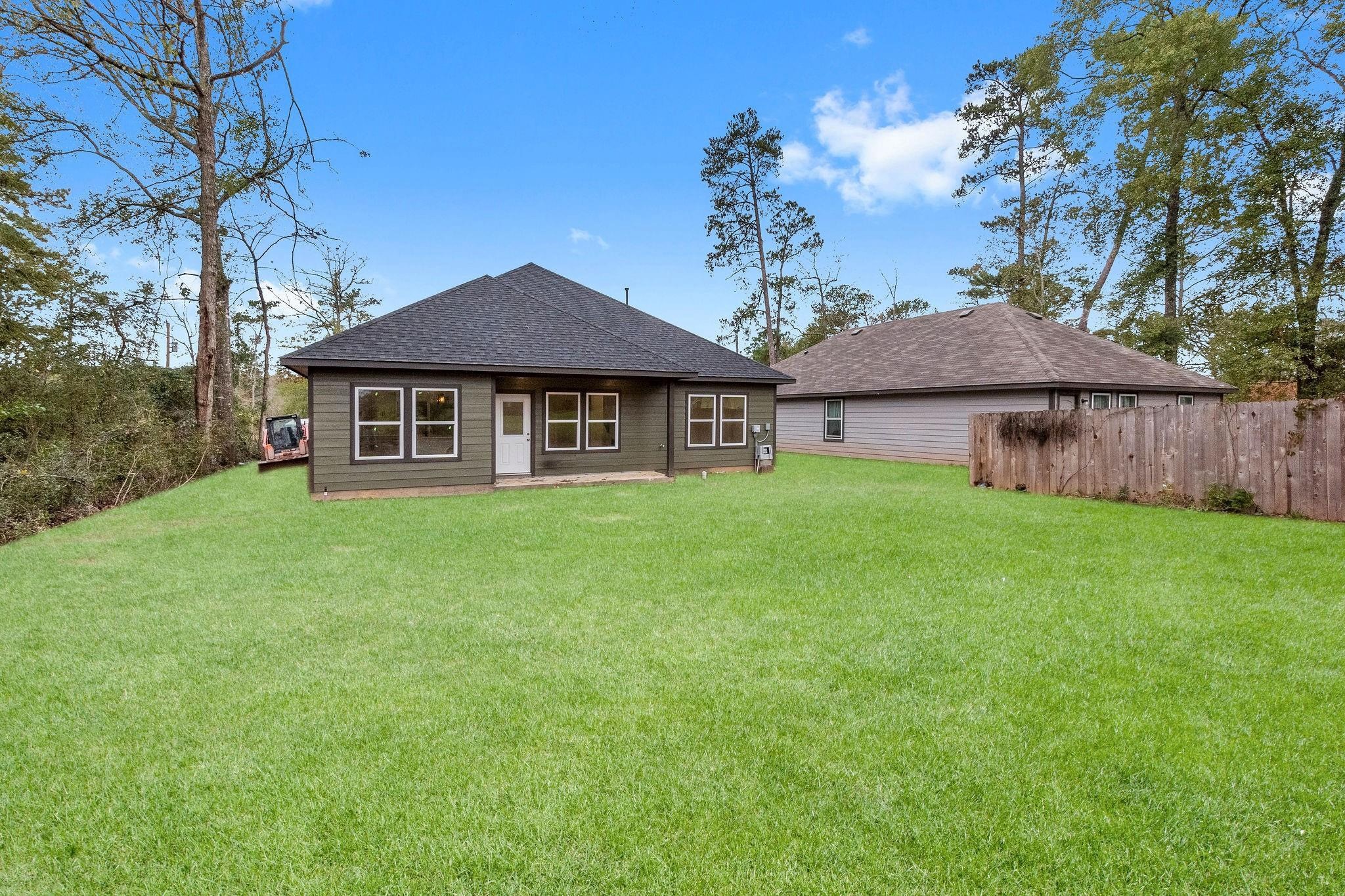 15479 Arrowhead Loop West Willis, TX 77378 - Photo 7 of 7 a front view of a house with garden