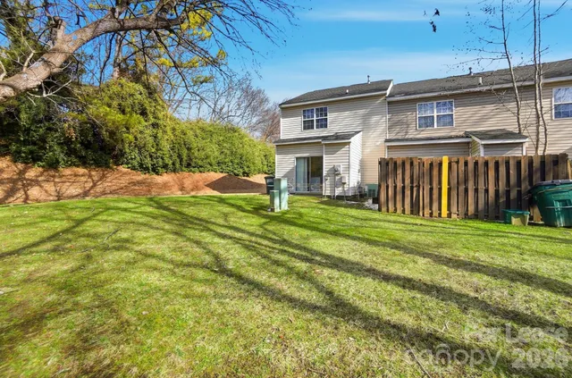 a view of a house with a yard and sitting area