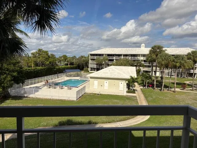 a view of a swimming pool with furniture