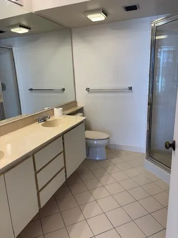 a bathroom with a sink a toilet and mirror
