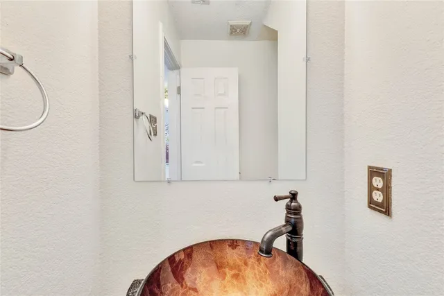 an empty room with a window and a ceiling fan