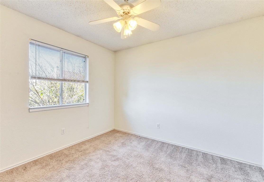 3600 Cheyenne Street Round Rock, TX 78665 - Photo 16 of 36 an empty room with a window and a ceiling fan