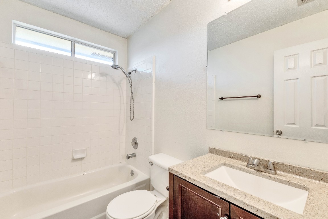 3600 Cheyenne Street Round Rock, TX 78665 - Photo 17 of 36 a bathroom with a granite countertop sink toilet and shower