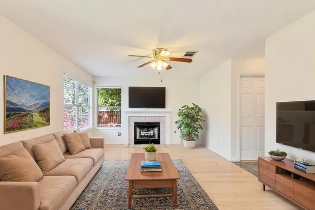 a living room with furniture fireplace and a flat screen tv