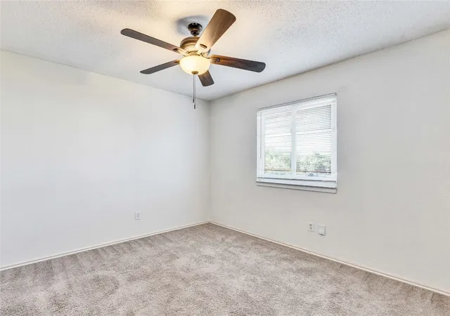 a view of a house with a yard and tree