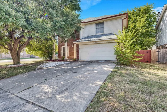 a view of tall trees with a yard