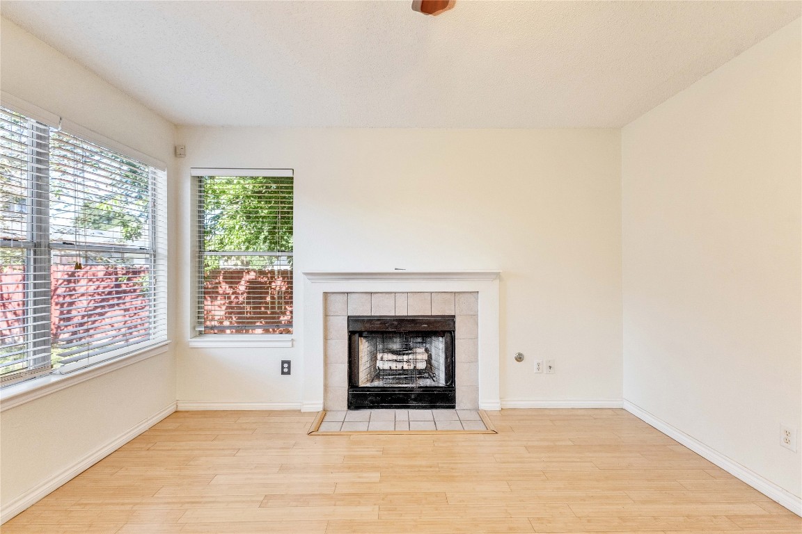 3600 Cheyenne Street Round Rock, TX 78665 - Photo 3 of 36 a living room with a fireplace and a floor to ceiling window