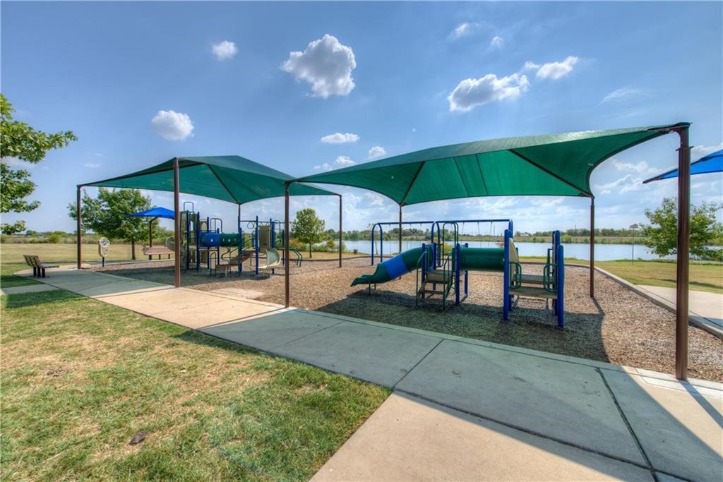 3600 Cheyenne Street Round Rock, TX 78665 - Photo 32 of 36 a view of a patio with a table and chairs under an umbrella
