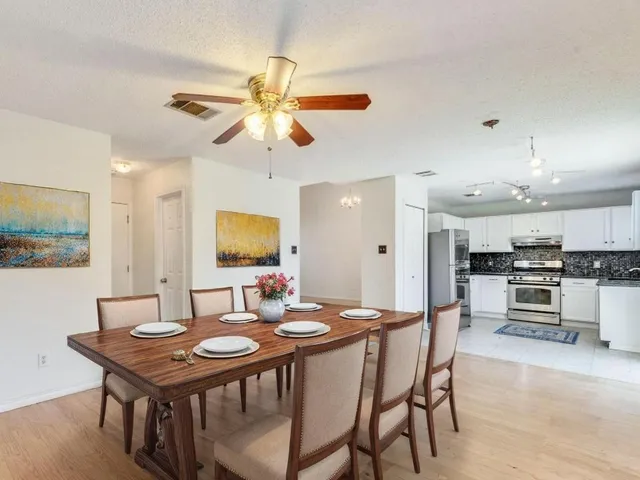 a view of a dining room with furniture and a chandelier