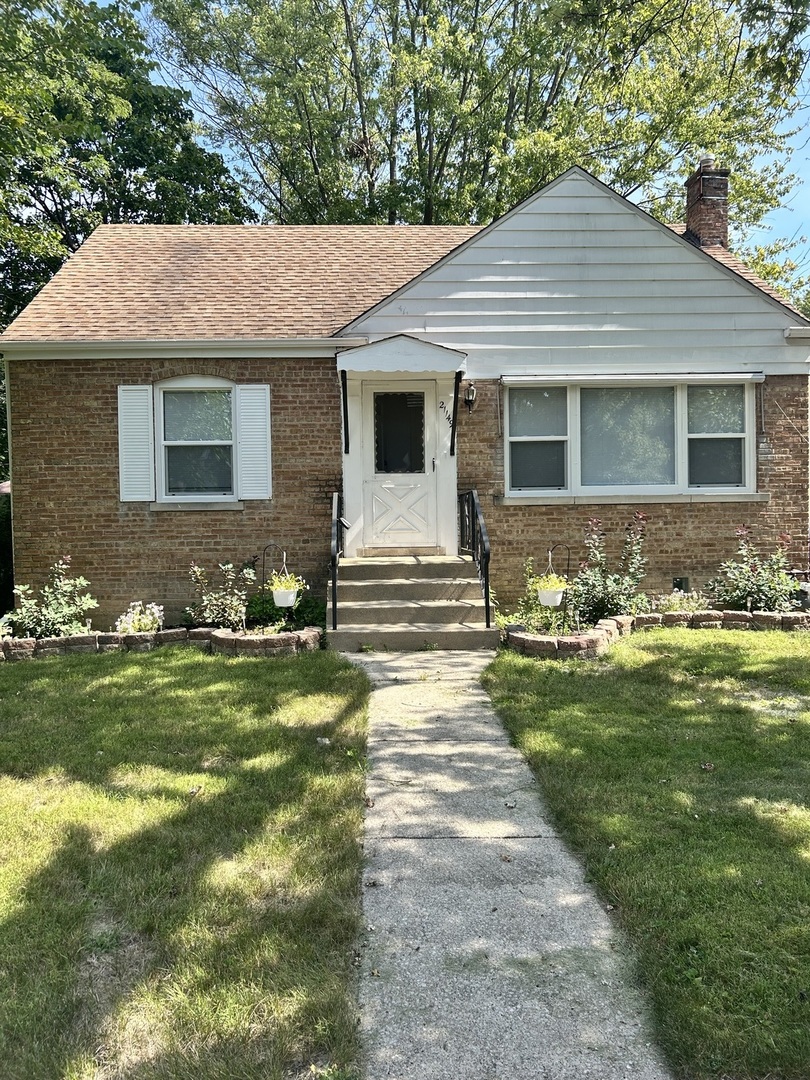 a front view of a house with a garden
