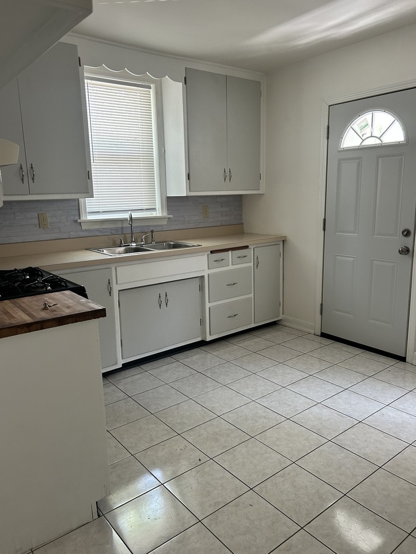21149 Main Street Matteson, IL 60443 - Photo 2 of 11 a kitchen with a sink cabinets and window