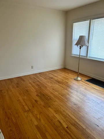 a view of an empty room and wooden floor