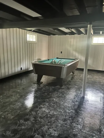 a view of a room with table and chairs