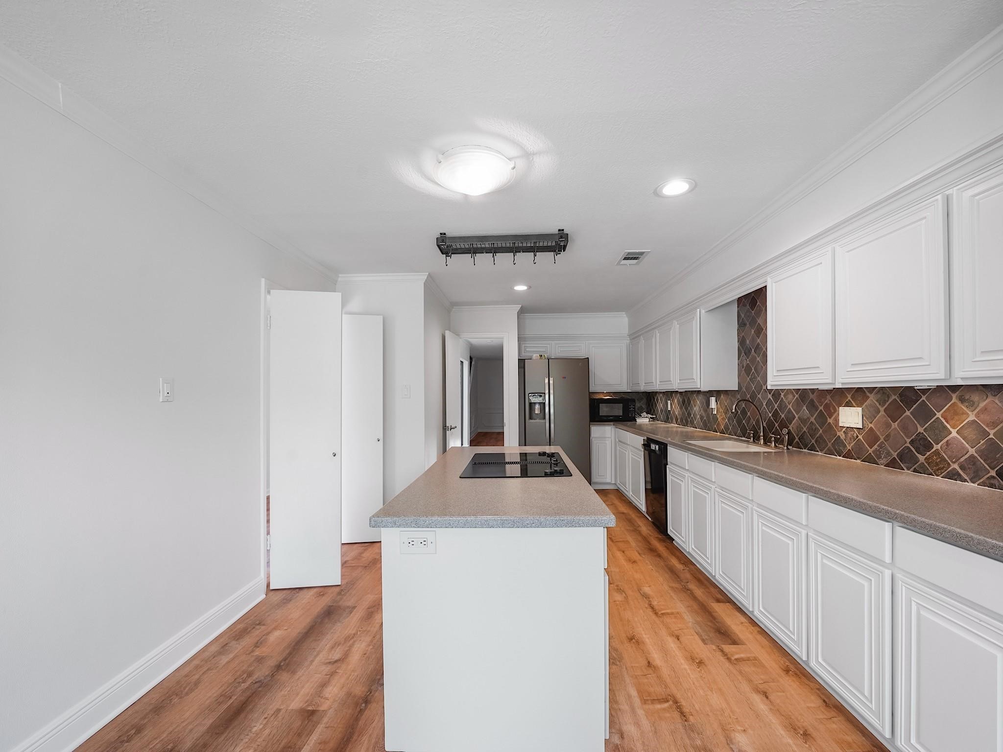 910 Enclave Parkway Houston, TX 77077 - Photo 11 of 42 Central island prep space with bar seating potential and sightlines to the atrium.